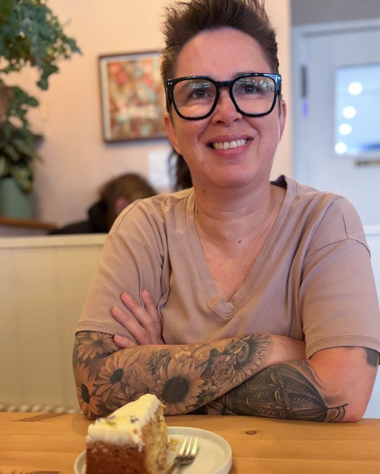Marlene smiling at a café table